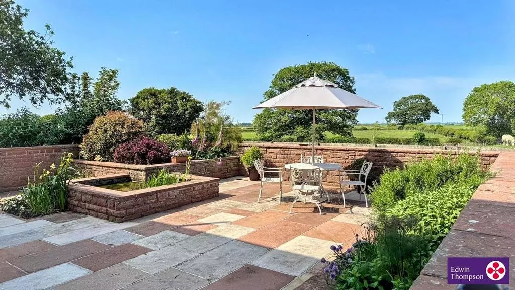 Kirkland House's landscaped patio and open countryside beyond