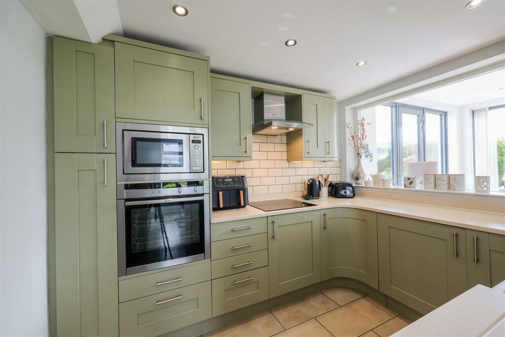 Roxboro's bright kitchen with sage green cabinetry